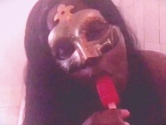 Ebony Girl in a Masquerade Mask Licking a Cherry Ice Pop & Put All Over Her Thumb