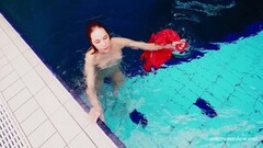 Cute babe in red sexy open dress swimming Thumb